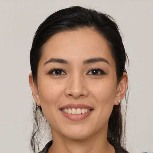 Joyful latino young-adult female with medium  brown hair and brown eyes