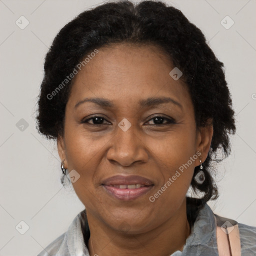 Joyful black adult female with short  brown hair and brown eyes