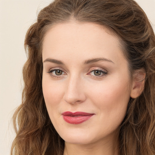 Joyful white young-adult female with long  brown hair and green eyes