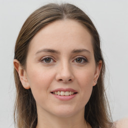 Joyful white young-adult female with long  brown hair and grey eyes