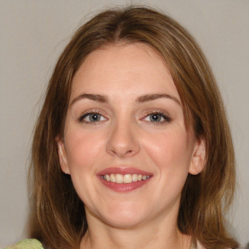 Joyful white young-adult female with medium  brown hair and blue eyes