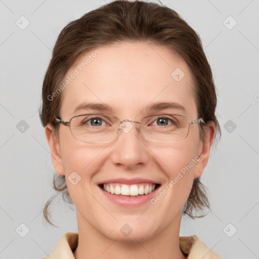 Joyful white adult female with medium  brown hair and grey eyes