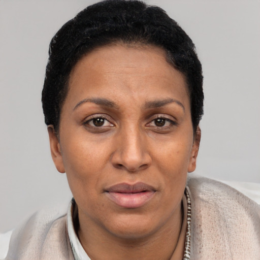 Joyful black adult female with short  brown hair and brown eyes