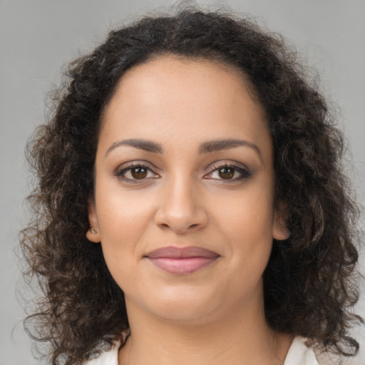 Joyful latino young-adult female with long  brown hair and brown eyes