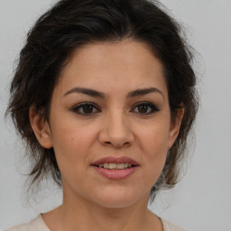 Joyful latino young-adult female with medium  brown hair and brown eyes