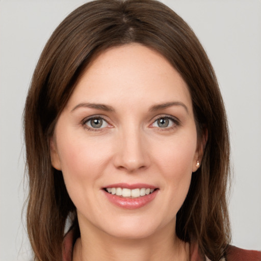 Joyful white young-adult female with medium  brown hair and grey eyes