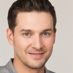 Joyful white young-adult male with short  brown hair and grey eyes