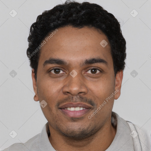 Joyful black young-adult male with short  black hair and brown eyes