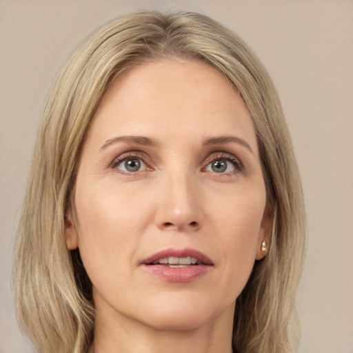 Joyful white adult female with long  brown hair and grey eyes