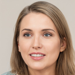 Joyful white young-adult female with long  brown hair and grey eyes