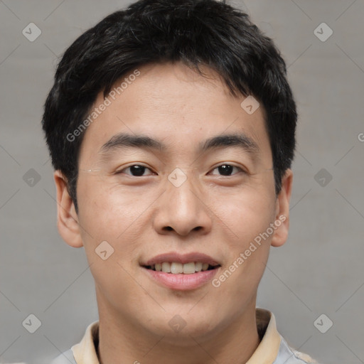 Joyful asian young-adult male with short  brown hair and brown eyes