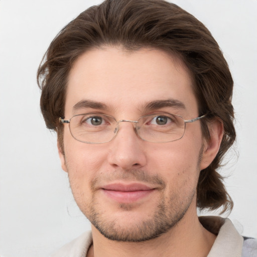 Joyful white adult male with short  brown hair and grey eyes