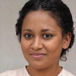 Joyful black young-adult female with medium  brown hair and brown eyes