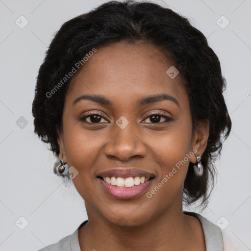 Joyful black young-adult female with long  black hair and brown eyes