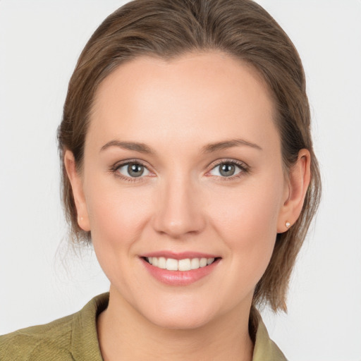 Joyful white young-adult female with medium  brown hair and grey eyes