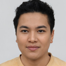 Joyful asian young-adult male with short  black hair and brown eyes