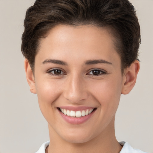 Joyful white young-adult female with short  brown hair and brown eyes