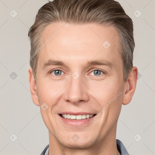 Joyful white adult male with short  brown hair and grey eyes