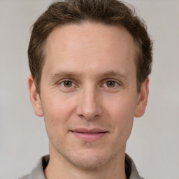 Joyful white adult male with short  brown hair and grey eyes