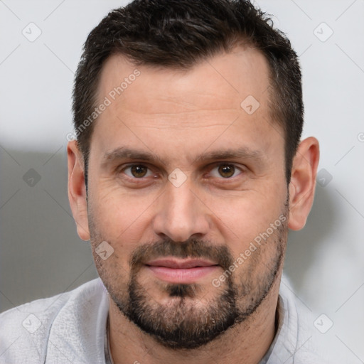 Joyful white adult male with short  brown hair and brown eyes