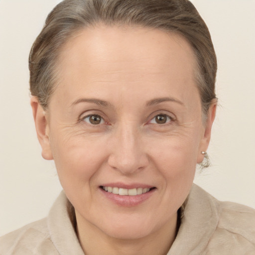 Joyful white adult female with medium  brown hair and brown eyes