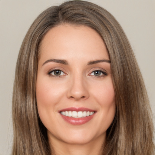 Joyful white young-adult female with long  brown hair and brown eyes