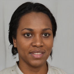 Joyful black young-adult female with medium  brown hair and brown eyes