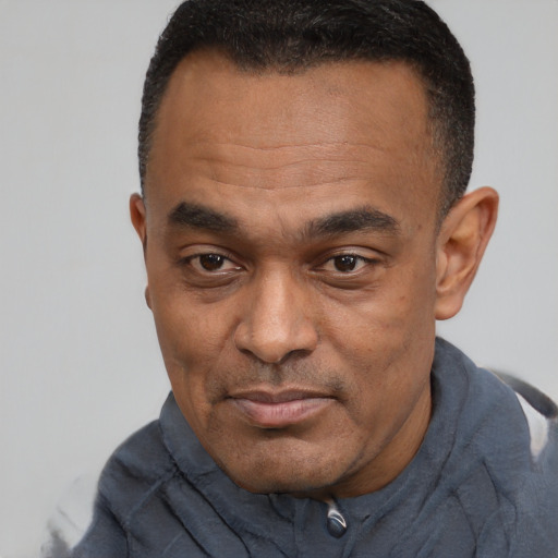 Neutral latino adult male with short  black hair and brown eyes