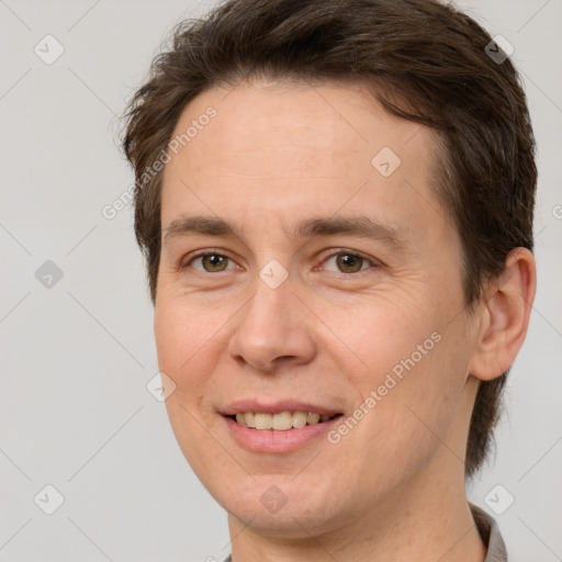 Joyful white adult female with short  brown hair and brown eyes