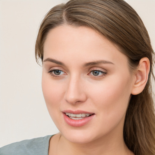 Joyful white young-adult female with long  brown hair and blue eyes