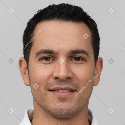 Joyful white young-adult male with short  black hair and brown eyes