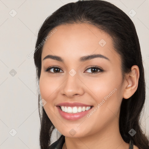 Joyful white young-adult female with long  black hair and brown eyes