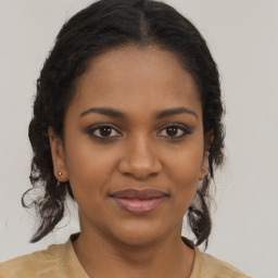 Joyful black young-adult female with long  brown hair and brown eyes