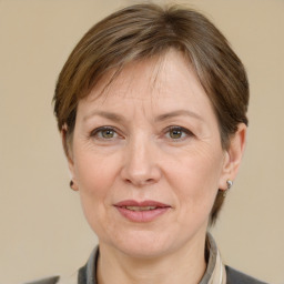 Joyful white adult female with medium  brown hair and grey eyes