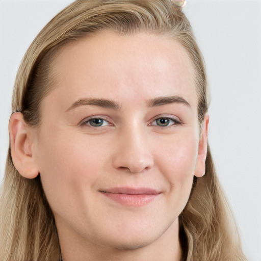 Joyful white young-adult female with long  brown hair and blue eyes