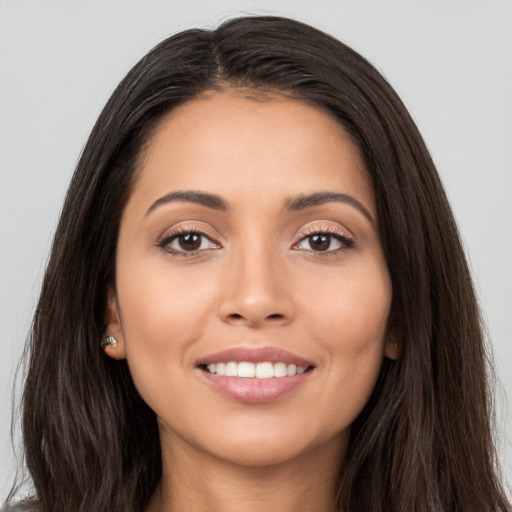 Joyful white young-adult female with long  brown hair and brown eyes