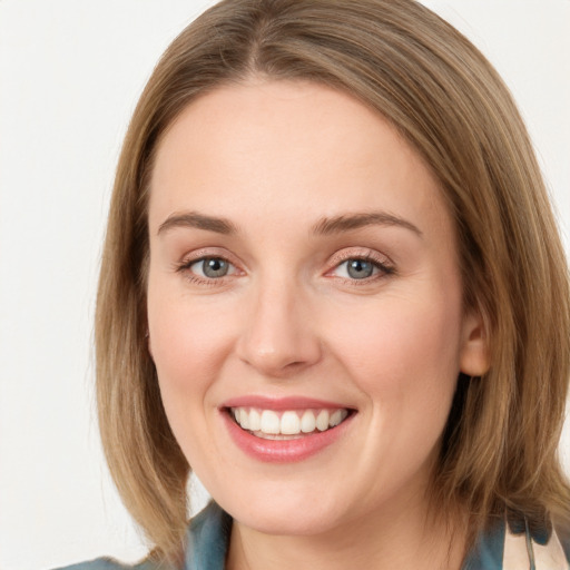 Joyful white young-adult female with medium  brown hair and blue eyes