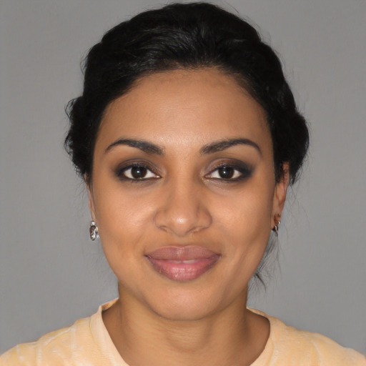 Joyful latino young-adult female with medium  black hair and brown eyes