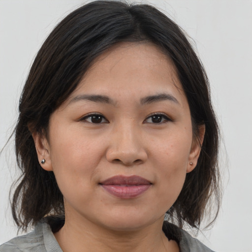 Joyful white young-adult female with medium  brown hair and brown eyes