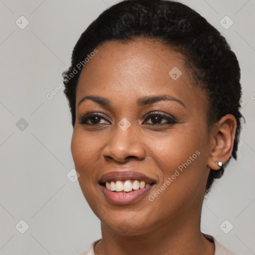 Joyful black young-adult female with short  black hair and brown eyes