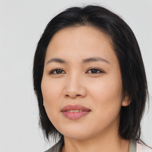 Joyful asian young-adult female with medium  black hair and brown eyes