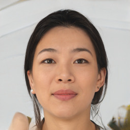 Joyful asian young-adult female with medium  brown hair and brown eyes