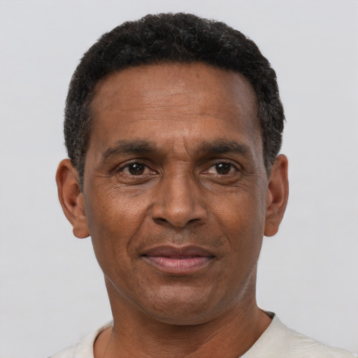 Joyful latino adult male with short  black hair and brown eyes