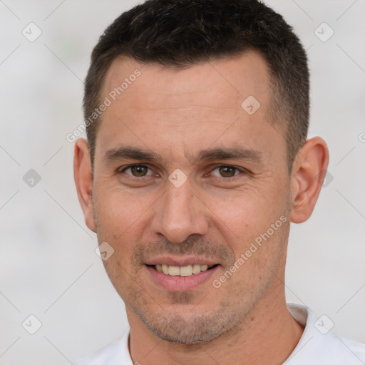 Joyful white adult male with short  brown hair and brown eyes