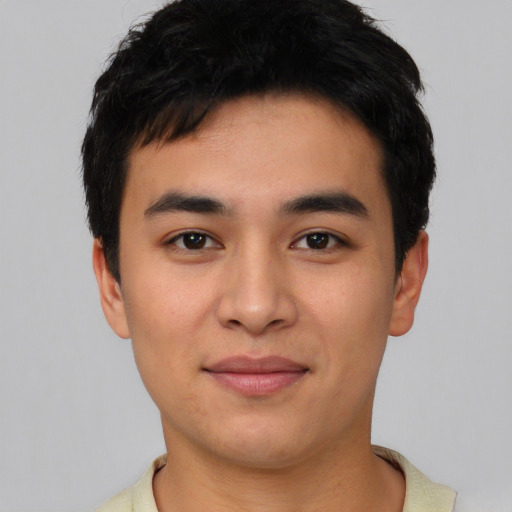 Joyful asian young-adult male with short  black hair and brown eyes