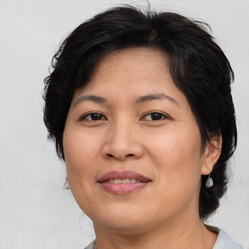 Joyful asian adult female with medium  brown hair and brown eyes