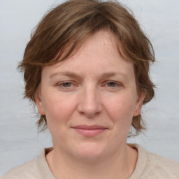 Joyful white young-adult female with medium  brown hair and blue eyes