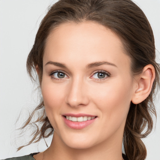 Joyful white young-adult female with medium  brown hair and blue eyes