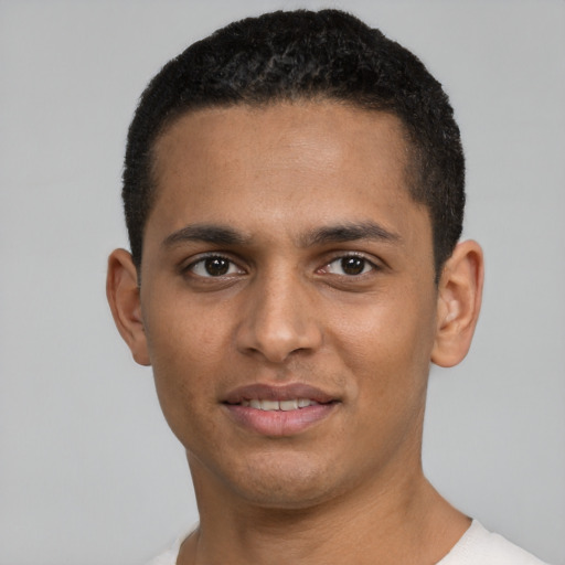 Joyful black young-adult male with short  black hair and brown eyes