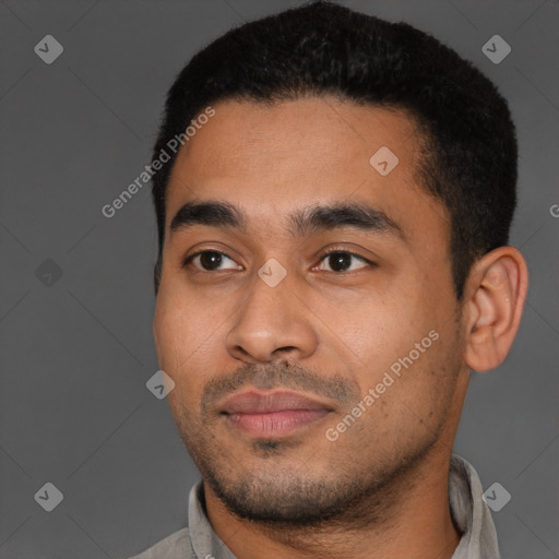 Joyful latino young-adult male with short  black hair and brown eyes